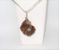 Necklace with a unique ammonite pendant on a white background