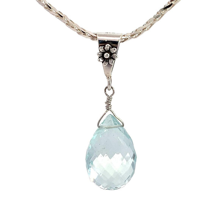 a sterling silver pendant featuring an aquamarine briolette pendant with a floral inspired bail on a silver chain on a white background front view