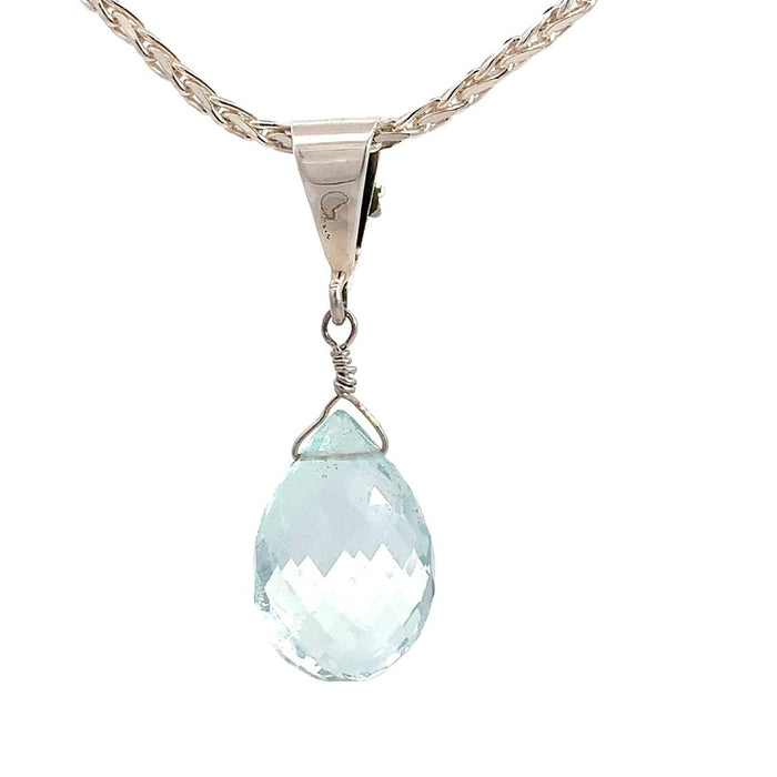a sterling silver pendant featuring an aquamarine briolette pendant with a floral inspired bail on a silver chain on a white background back view