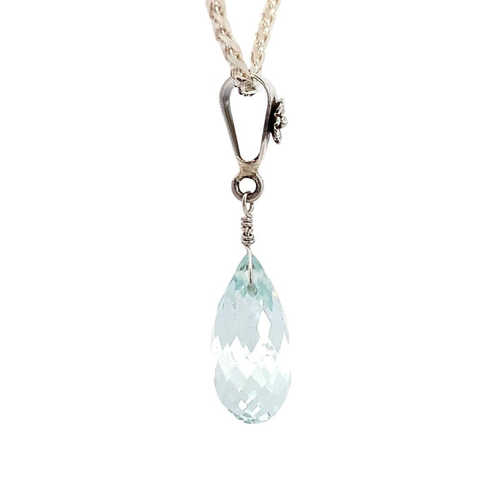 a sterling silver pendant featuring an aquamarine briolette pendant with a floral inspired bail on a silver chain on a white background side view