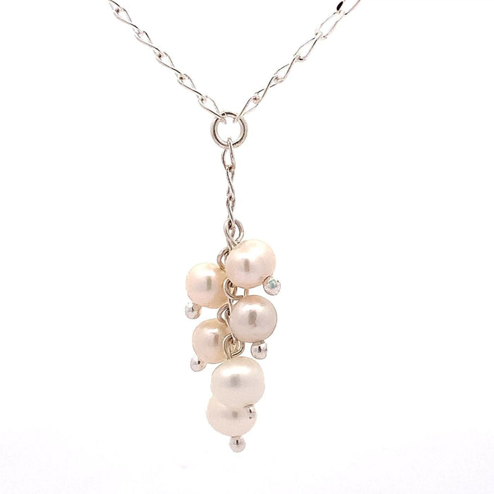 photo of a silver "Y" necklace with six pink pearls on a white background