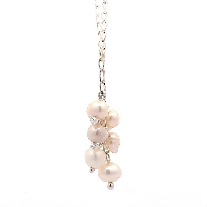 photo of a silver "Y" necklace with six pink pearls on a white background side view