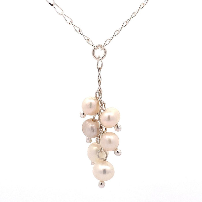 photo of a silver "Y" necklace with six pink pearls on a white background
