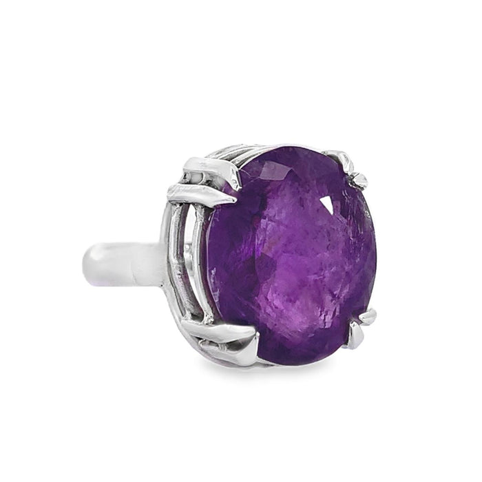 photo of an oval amethyst silver ring on a white background side view