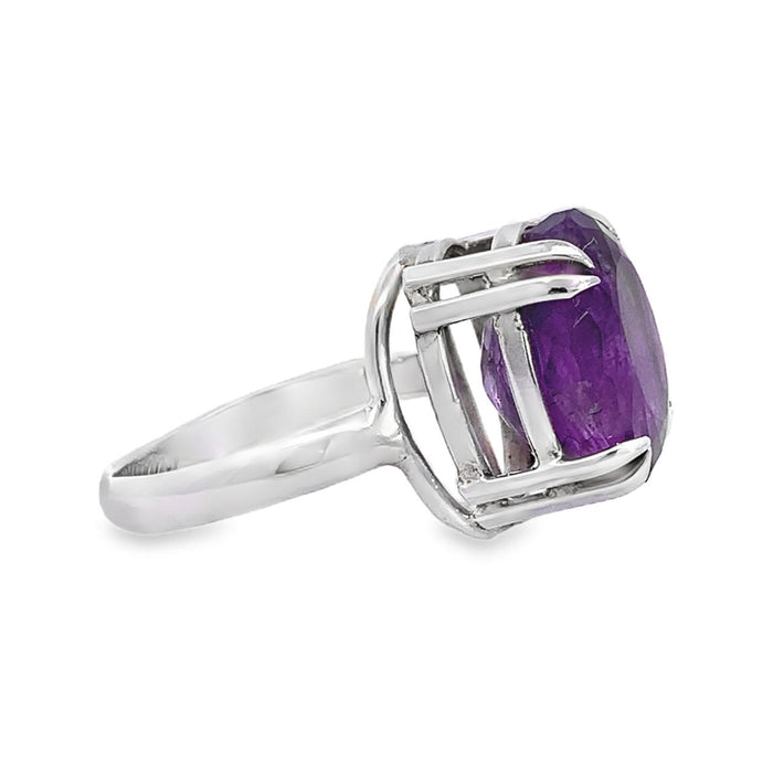 photo of an oval amethyst silver ring on a white background side view