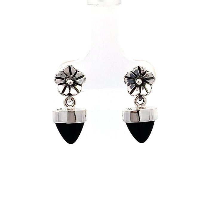 a sterling silver dangle earring with a bezel set black onyx bullet with a floral top on a white background front view