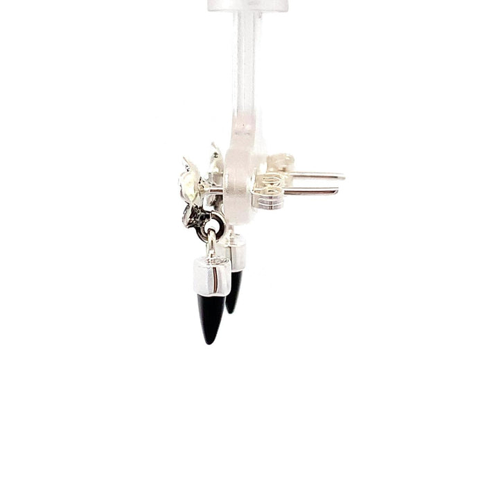 a sterling silver dangle earring with a bezel set black onyx bullet with a floral top on a white background side view