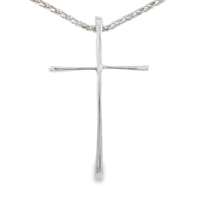 photo of a silver slender long cross pendant on a white background