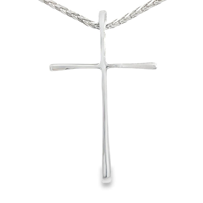photo of a silver slender long cross pendant on a white background