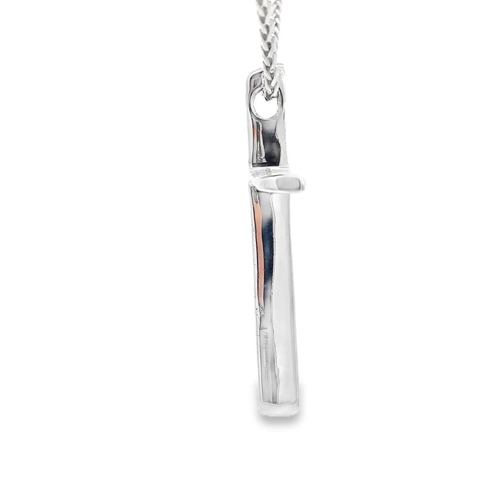 photo of a silver slender long cross pendant on a white background side view