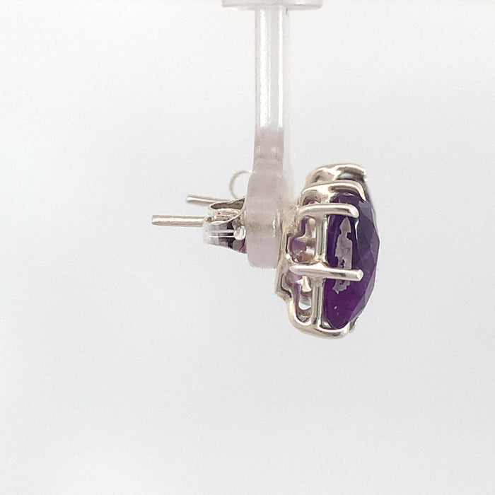 photo of a pair of silver amethyst earrings on a white background side view