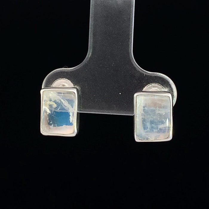 photo of a rectangular silver white moonstone stud earring on a black background