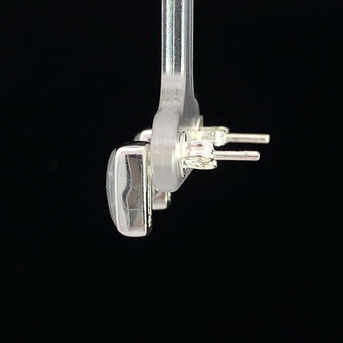photo of a rectangular silver white moonstone stud earring on a black background side view