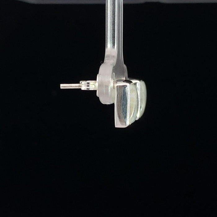 photo of a rectangular silver white moonstone stud earring on a black background side view