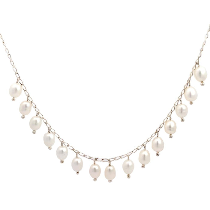 photo of a silver chain strung with dangling white freshwater pearls on a white background