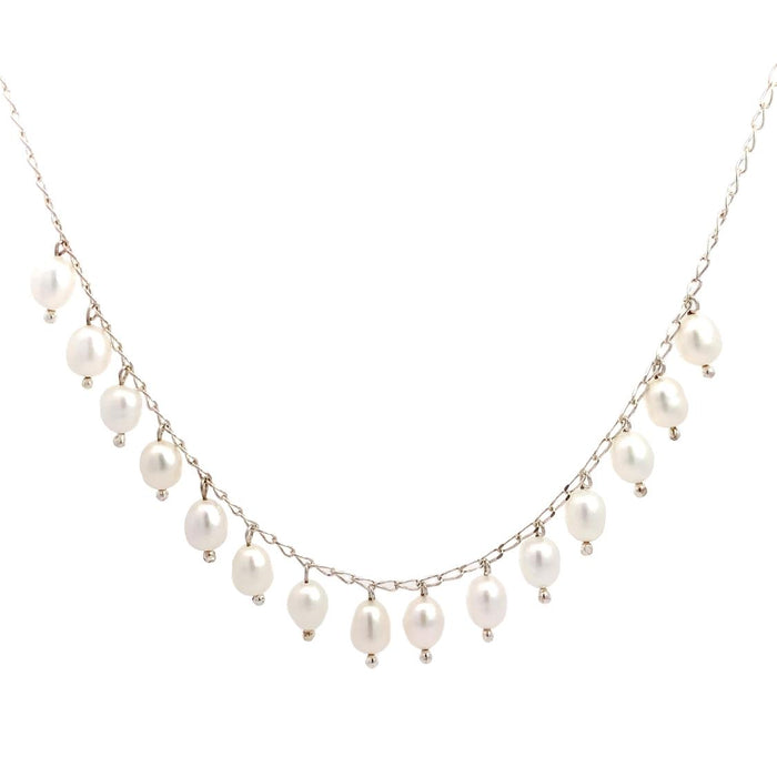 photo of a silver chain strung with dangling white freshwater pearls on a white background