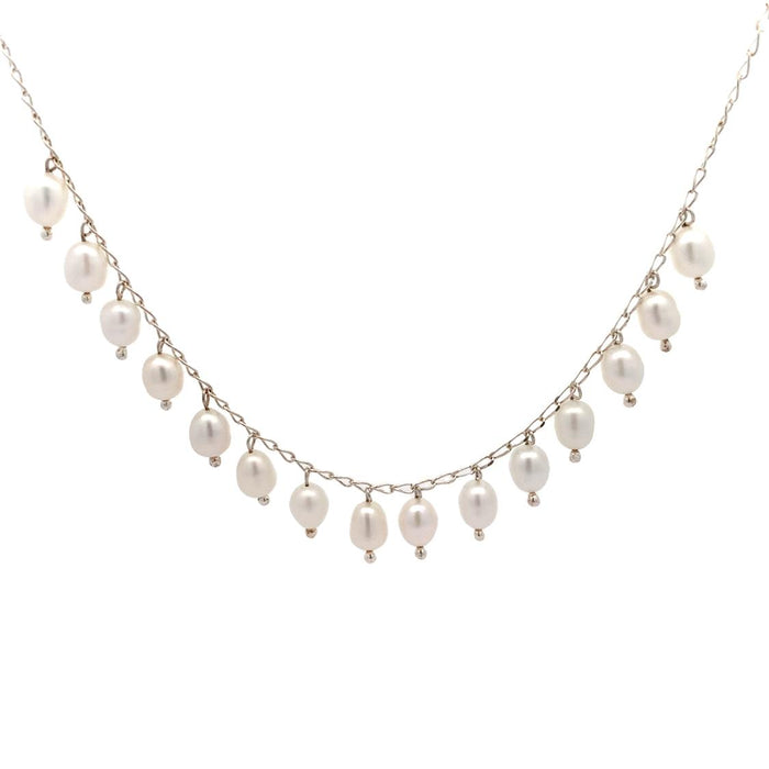 photo of a silver chain strung with dangling white freshwater pearls on a white background