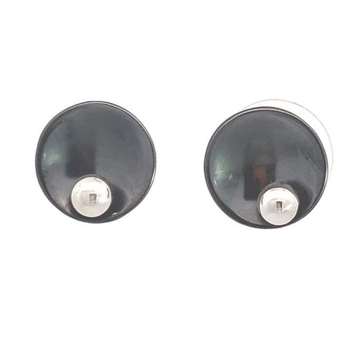 photo of a pair of black and silver circle shaped stud earrings on a white background