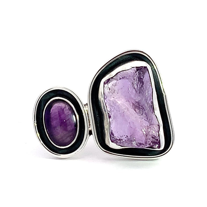 photo of a two stone amethyst silver ring with black oxidation surround on a white background