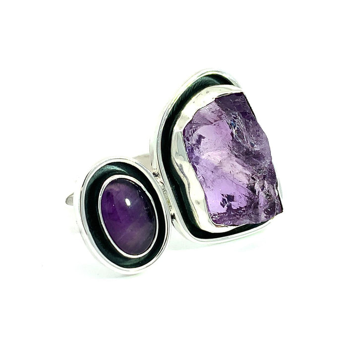 photo of a two stone amethyst silver ring with black oxidation surround on a white background