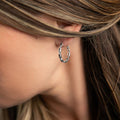 photo of a brunette model wearing a silver chain design hoop earring