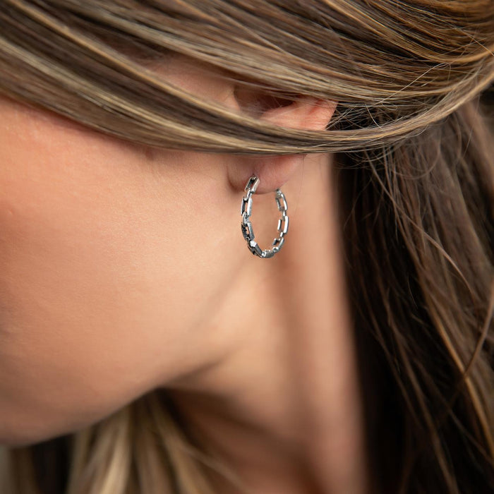 photo of a brunette model wearing a silver chain design hoop earring