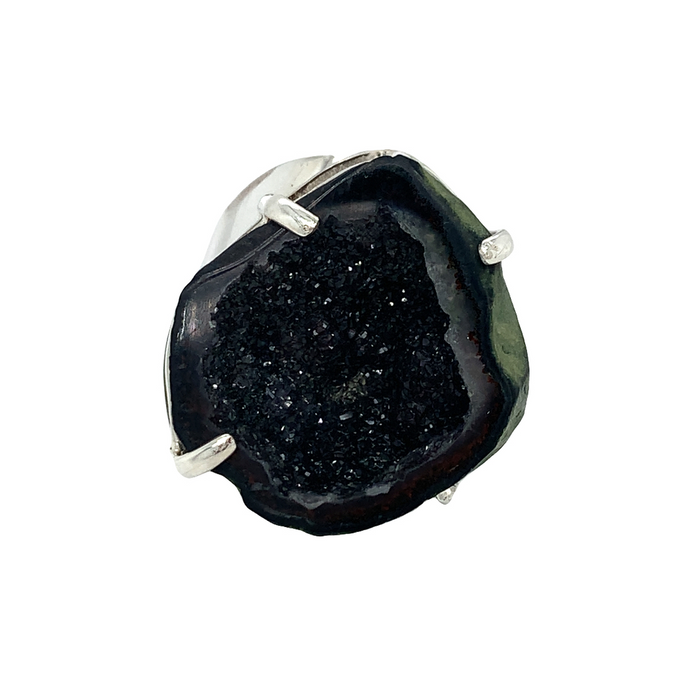 photo of a silver ring featuring a black geode on a white background
