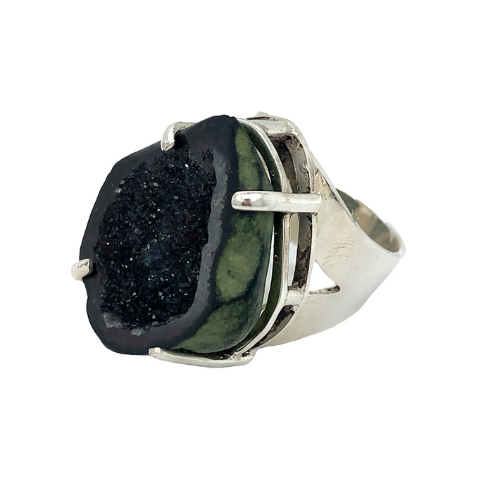 photo of a silver ring featuring a black geode on a white background
