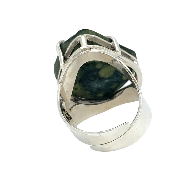 photo of a silver ring featuring a black geode on a white background rear view