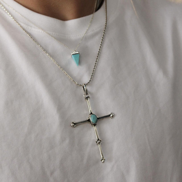 photo of a male model wearing two silver turquoise necklaces