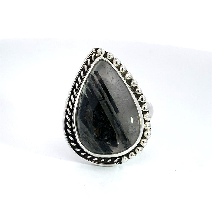photo of a silver ring set with a pear shape  black and white gem