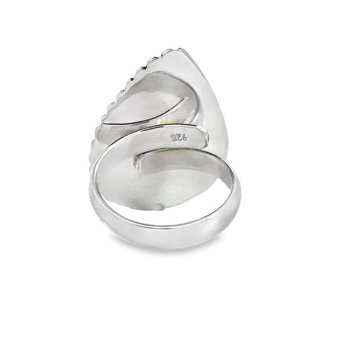 photo of a modern silver ring with a oval pink gemstone on a white background rear view