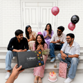 Group of people sitting on stairs with a Lofthouse chocolate box
