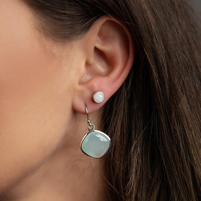 photo of a brunette model wearing a square blue Chalcedon silver dangle earring