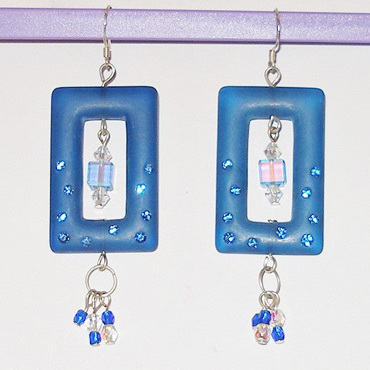 Blue square-framed earrings with crystal beads on a white background