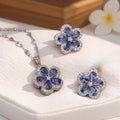 The Bluebell Icelia Set is a graceful 3-piece floral collection featuring a 5-petal pendant and matching earrings. Each petal is crafted with pastel blue stones in a teardrop shape, surrounding a silver zircon center. The outer rim of each flower is finished with fine-cut zircon stones for an icy brilliance that catches the light, and everyone’s eye.