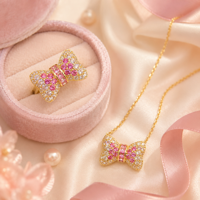 Cute, sparkling, and beautifully feminine, the Blush Bow Set is made for someone who loves soft romantic jewelry with a playful luxe touch. Designed with a crystal-studded bow necklace and matching ring, this set brings a sweet pink glow that feels perfect for everyday styling, special moments, or thoughtful gifting.