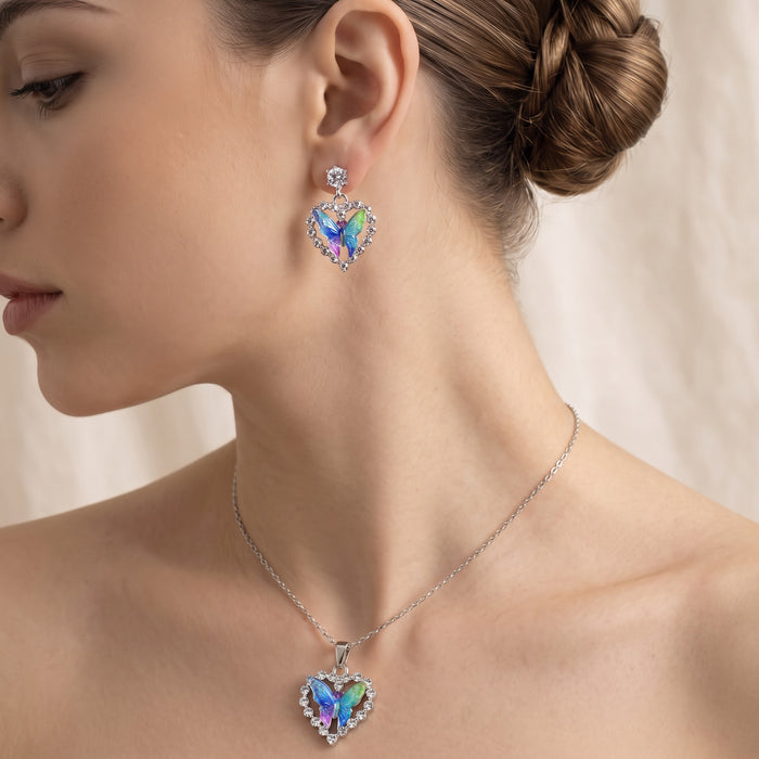 A symbol of love wrapped in delicate butterfly wings, this jewelry set captures the magic of transformation and the warmth of the heart. Featuring vibrant iridescent butterflies nestled inside sparkling heart-shaped frames, it creates a dreamy statement that feels romantic, whimsical, and effortlessly enchanting.