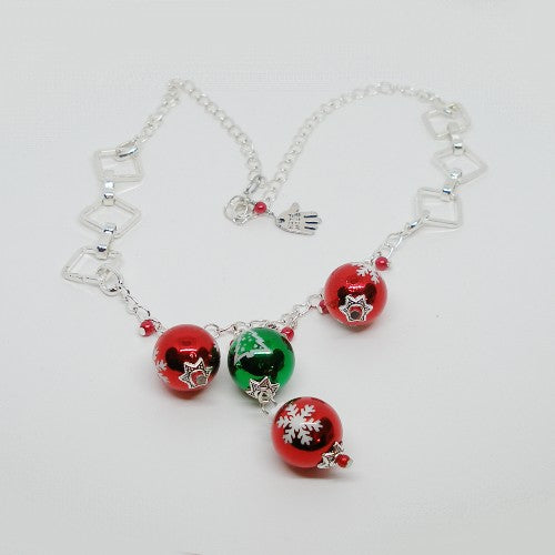 Necklace with red and green beads on a white background