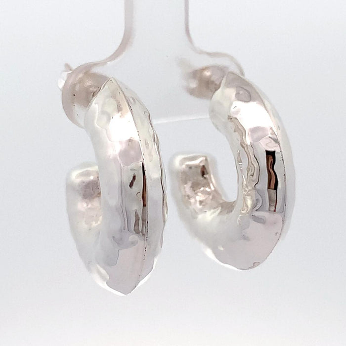 photo of chunky silver hoop earrings on a white background