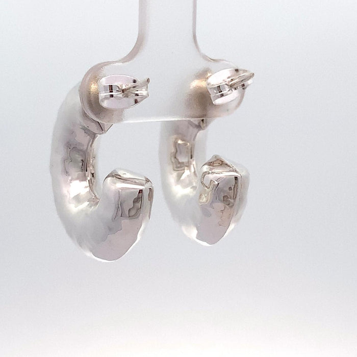 photo of chunky silver hoop earrings on a white background rear view