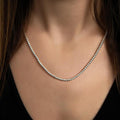 photo of a brunette model wearing a silver bead necklace