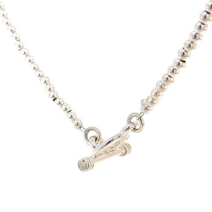 photo close up shot of a silver bead necklace