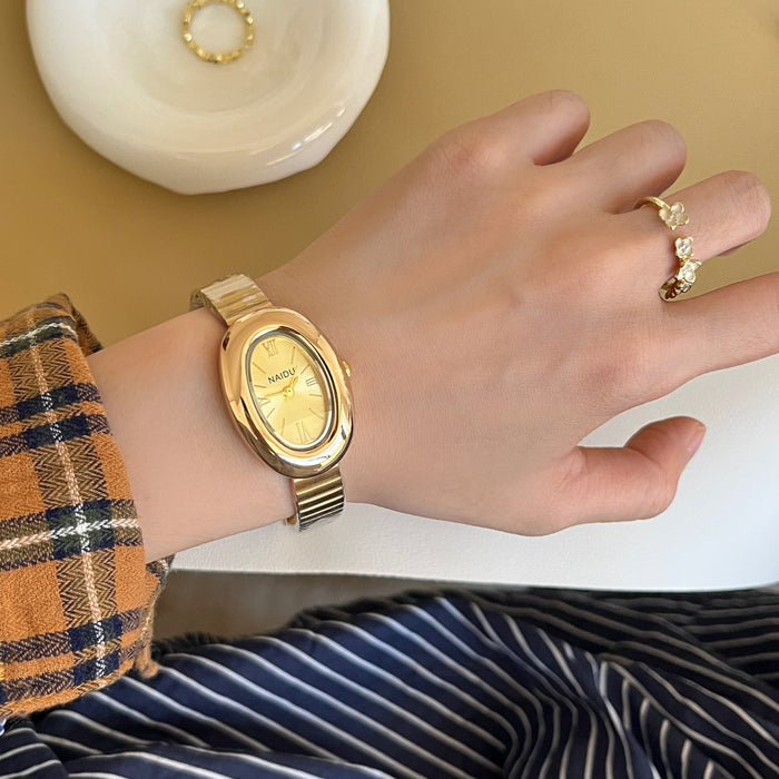 A refined oval dial wrapped in a smooth golden frame, designed to move effortlessly with your everyday moments. Minimal yet expressive, this watch brings quiet luxury to every wrist, perfect for daily wear or thoughtful gifting.