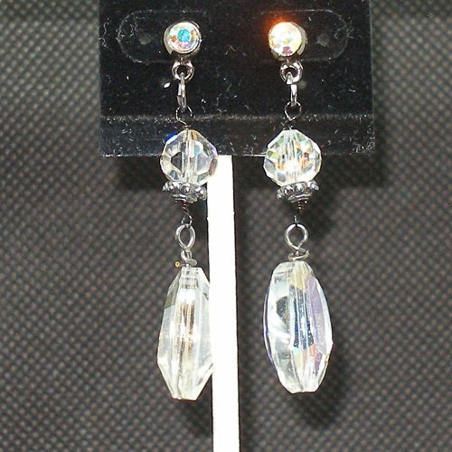 Crystal drop earrings on a black earring card with a gray background