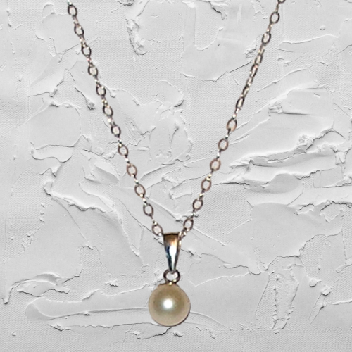 Pearl necklace on a textured white background