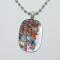 Multicolored glass pendant on a silver chain against a white background