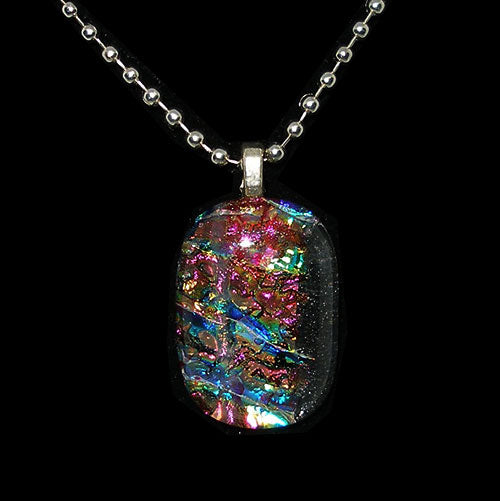 Multicolored pendant on a chain against a black background