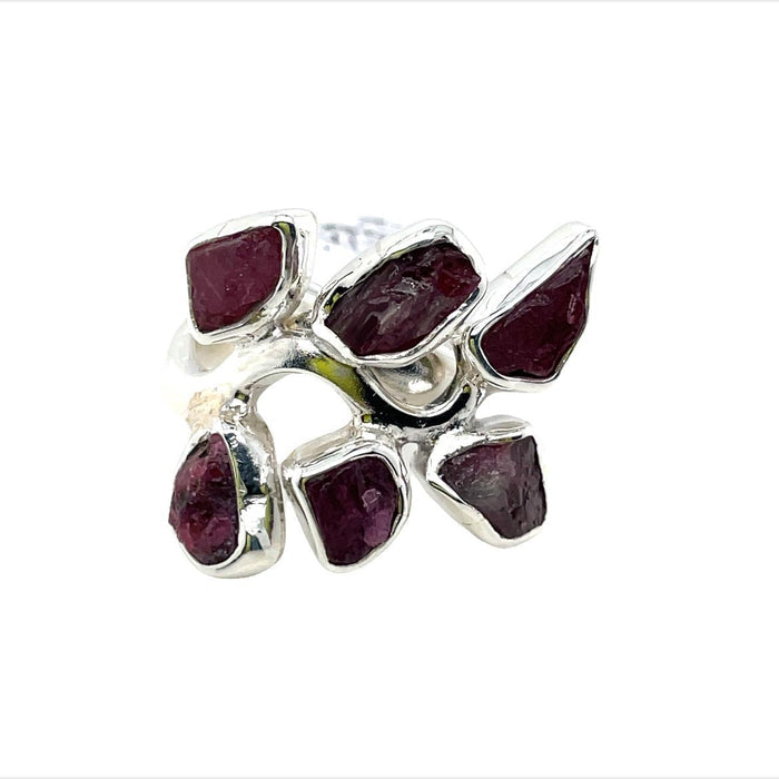 photo of a silver six stone red garnet ring on a white background