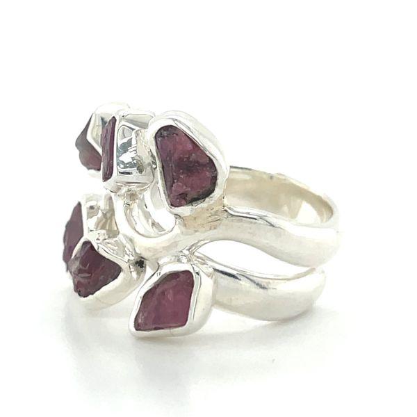 photo of a silver six stone garnet ring on a white background side view